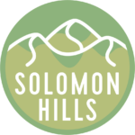 solomon hills logo, represented by a green background with white hills